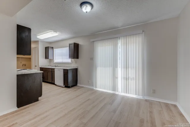 a view of kitchen with granite countertop cabinets and wooden floor