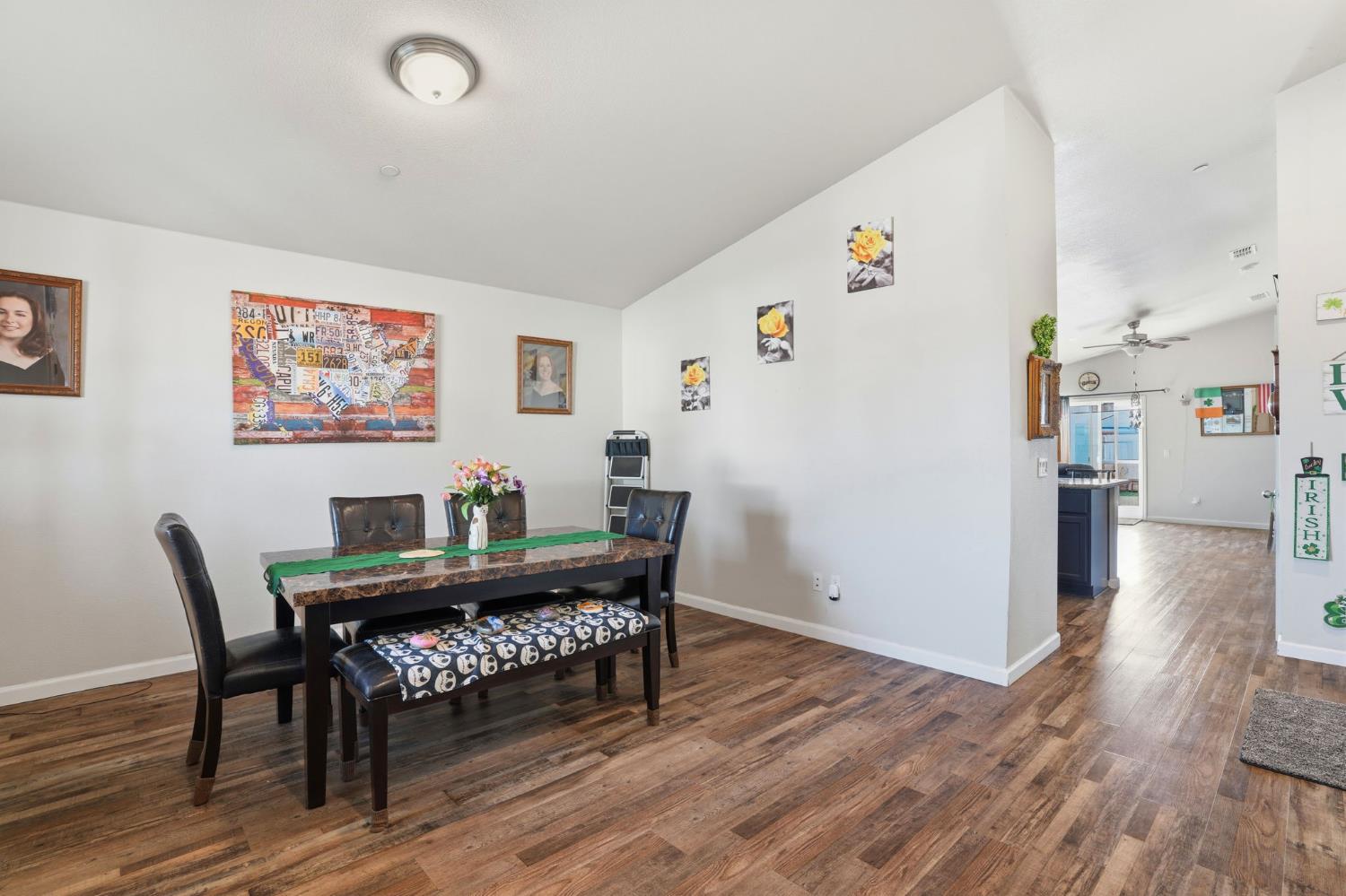 296 Dena Court Merced, CA 95341 - Photo 15 of 34 a view of a dining room with furniture and wooden floor