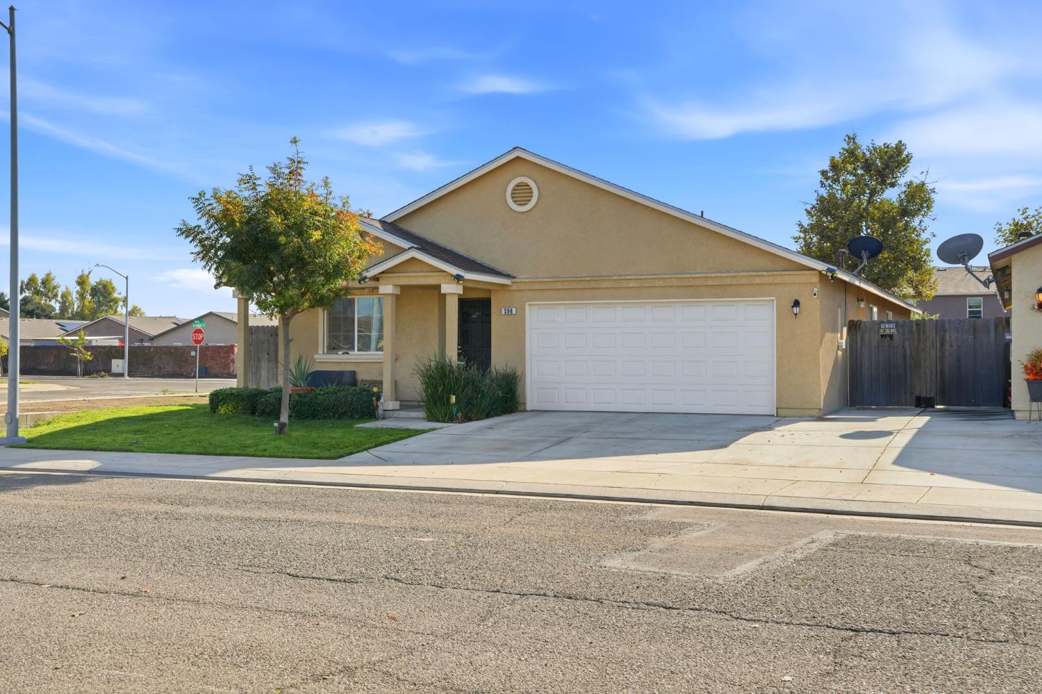 296 Dena Court Merced, CA 95341 - Photo 2 of 34 a front view of a house with a yard and garage