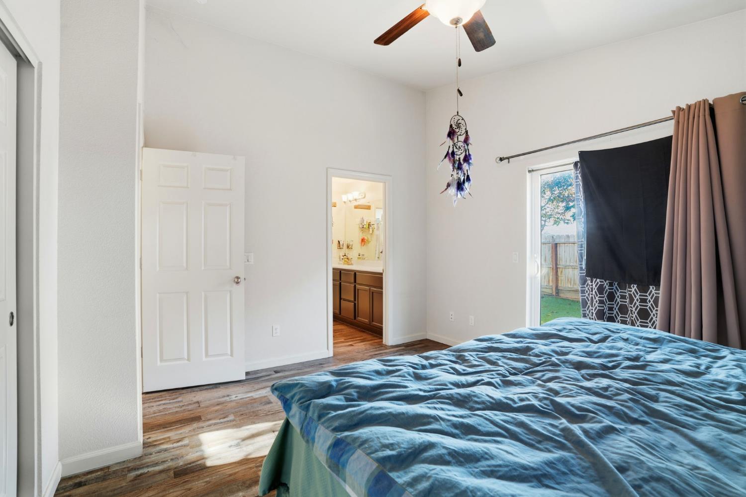 296 Dena Court Merced, CA 95341 - Photo 23 of 34 a bedroom with a bed and a chandelier