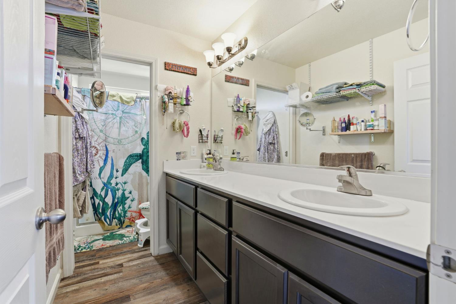 296 Dena Court Merced, CA 95341 - Photo 26 of 34 a bathroom with a sink double vanity and a mirror