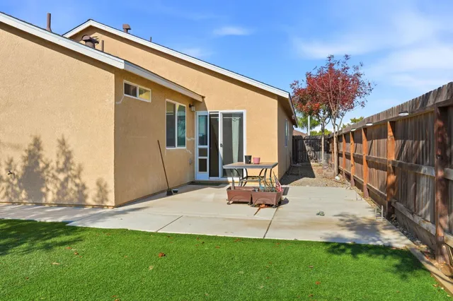 a view of a backyard with furniture and a backyard