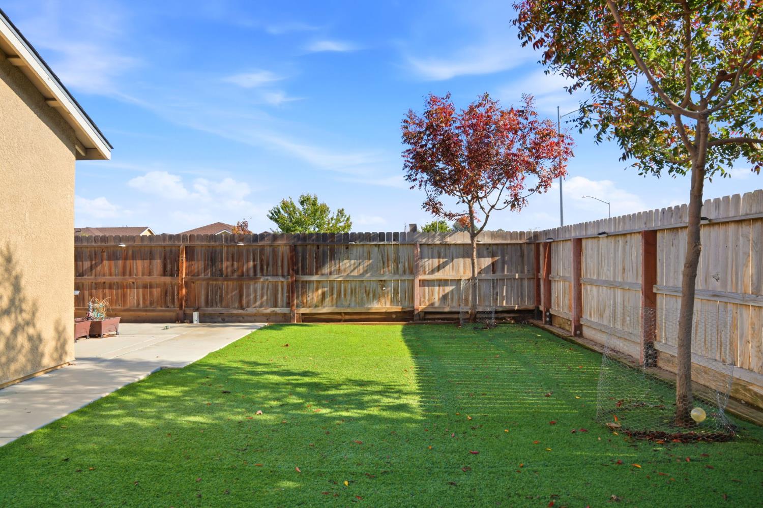 296 Dena Court Merced, CA 95341 - Photo 30 of 34 a view of a swimming pool with a bench and trees around