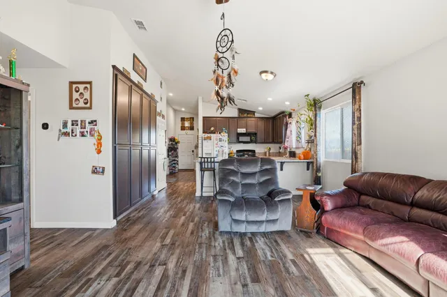 a living room with furniture or kitchen and a wooden floor