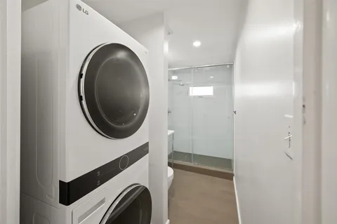 a bathroom with a sink mirror and a shower