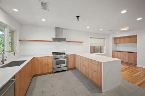 a kitchen with stainless steel appliances granite countertop a stove and a refrigerator