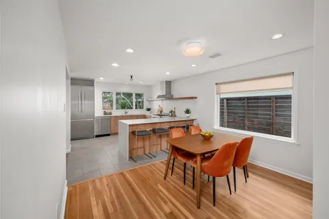 a view of a dining room with furniture and wooden floor