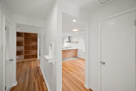 a view of a room with wooden floor and a window