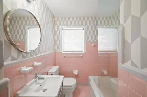 a bathroom with a sink mirror and vanity