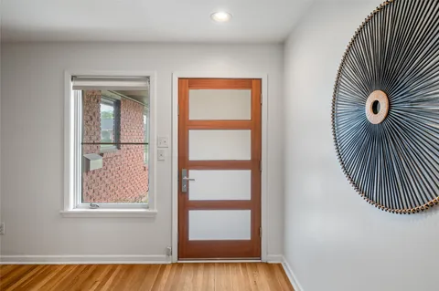 a dining room with furniture and wooden floor