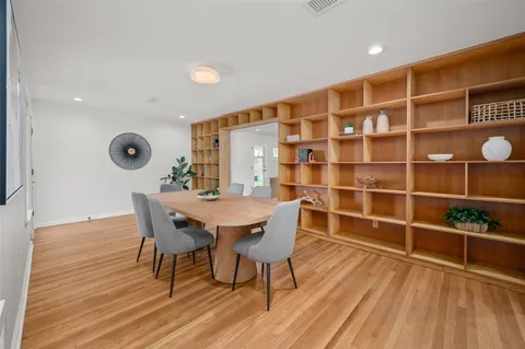 a view of a bedroom with wooden floor