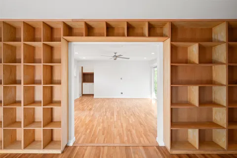 a view of empty room with wooden floor