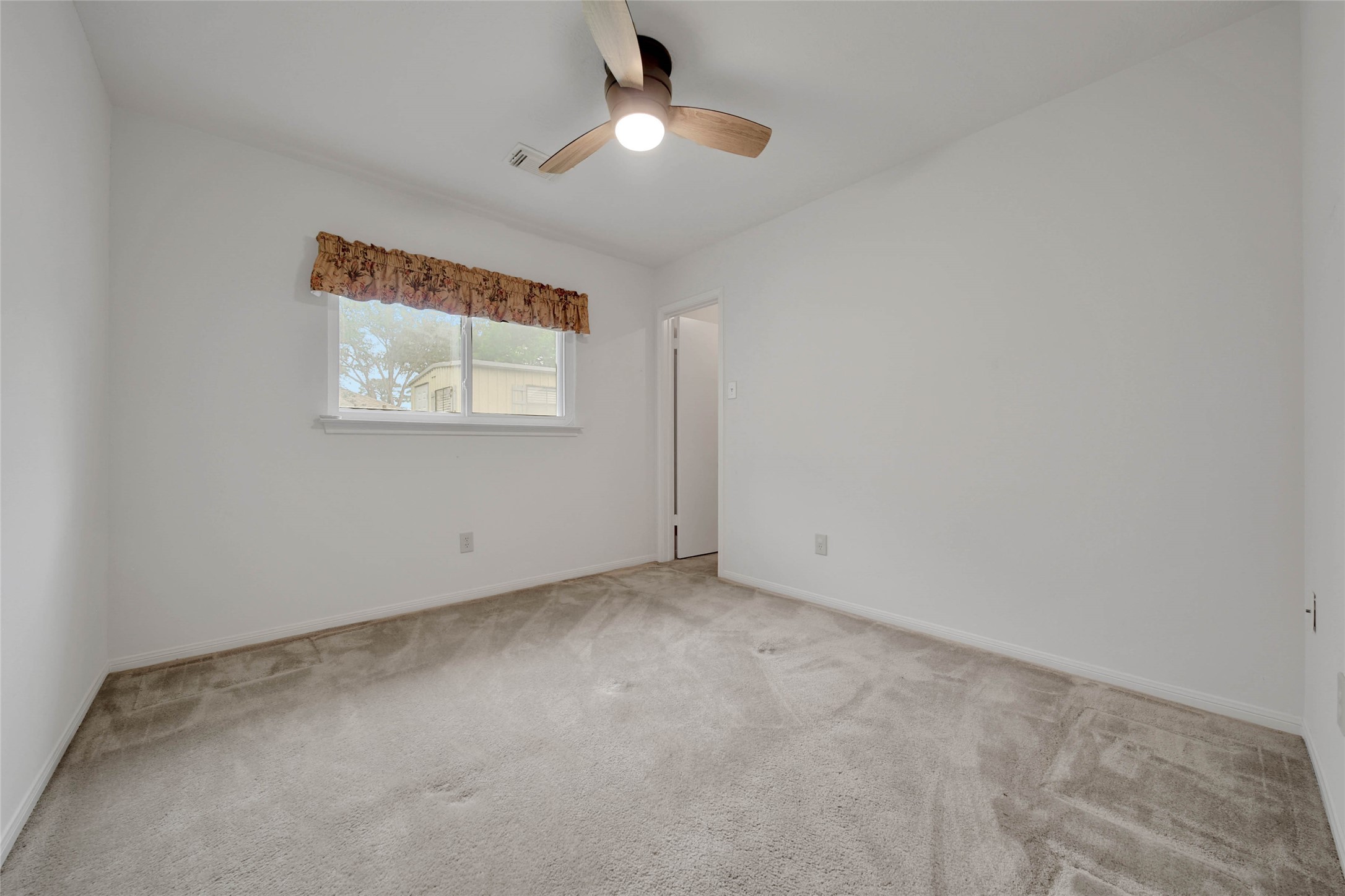 5010 Cupids Bower Court Spring, TX 77388 - Photo 23 of 40 an empty room with a view of a kitchen
