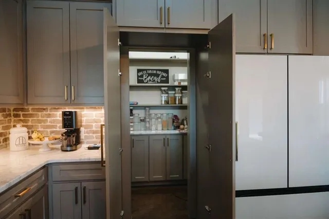 a kitchen with stainless steel appliances a refrigerator and cabinets