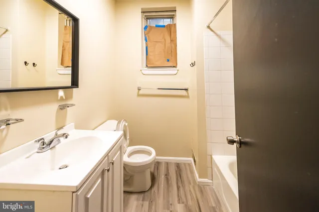 a bathroom with a sink toilet and mirror