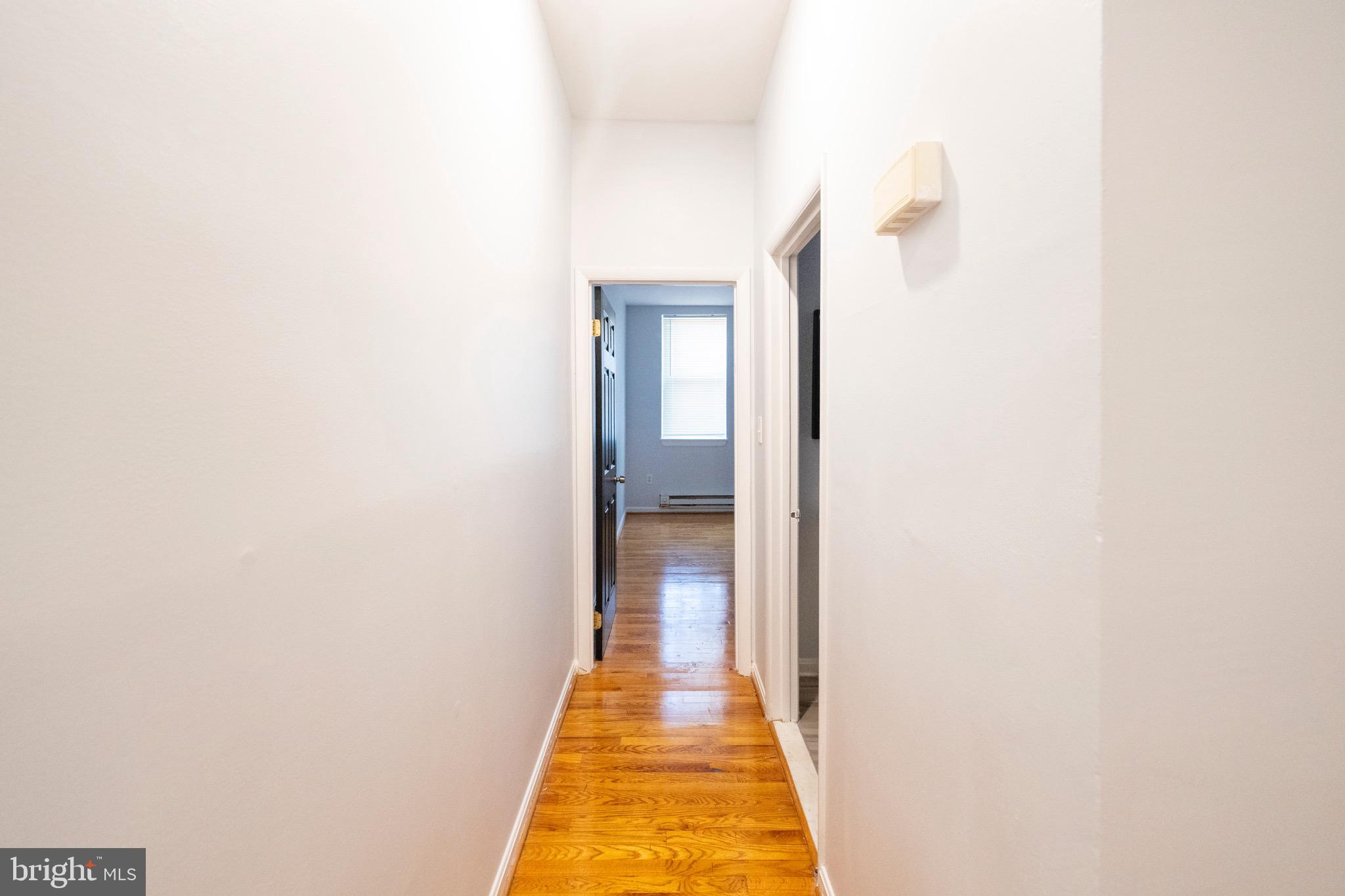 812 Newington Avenue Baltimore, MD 21217 - Photo 18 of 38 a view of a hallway with wooden floor
