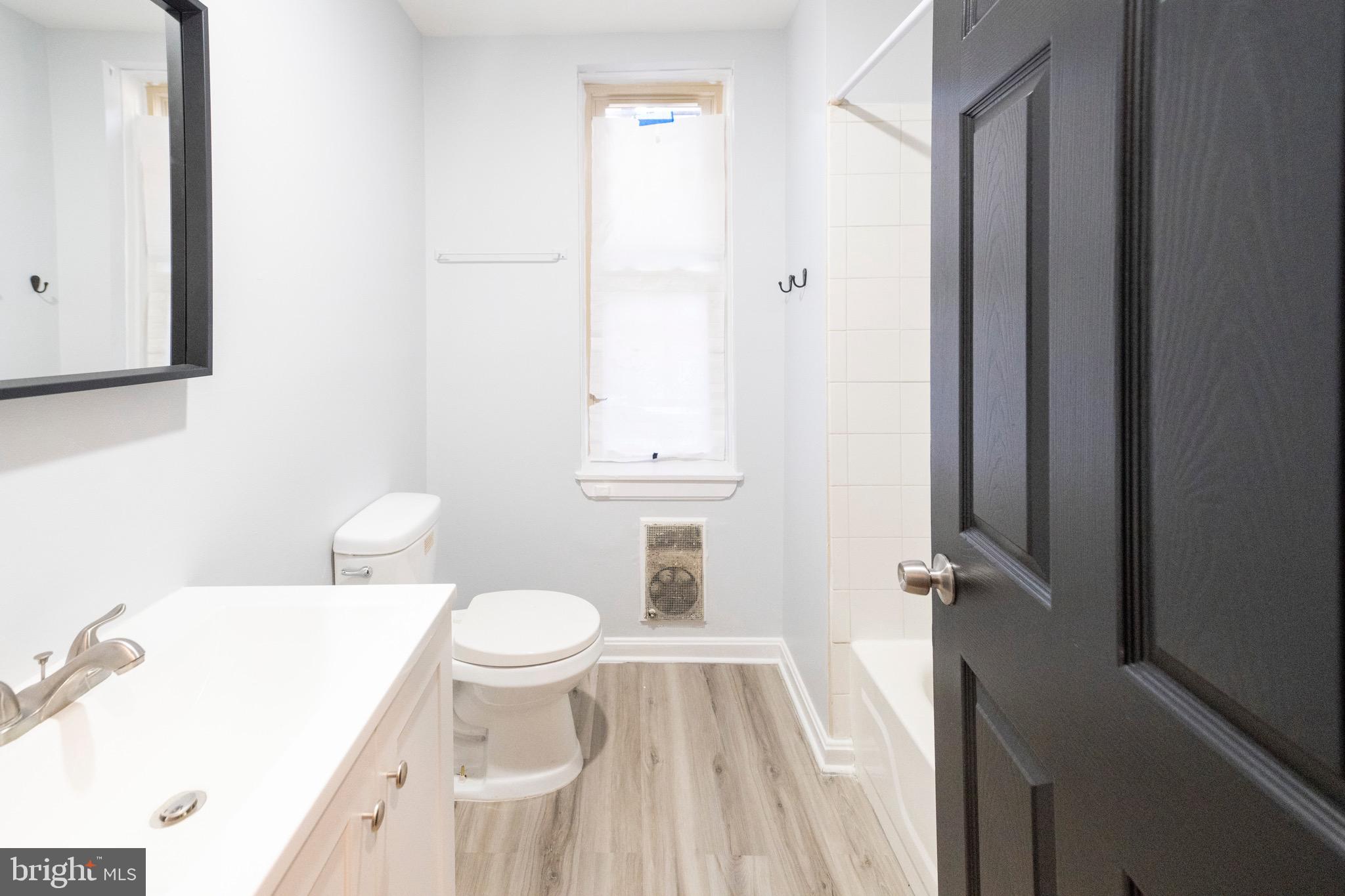 812 Newington Avenue Baltimore, MD 21217 - Photo 19 of 38 a bathroom with a sink a toilet and shower