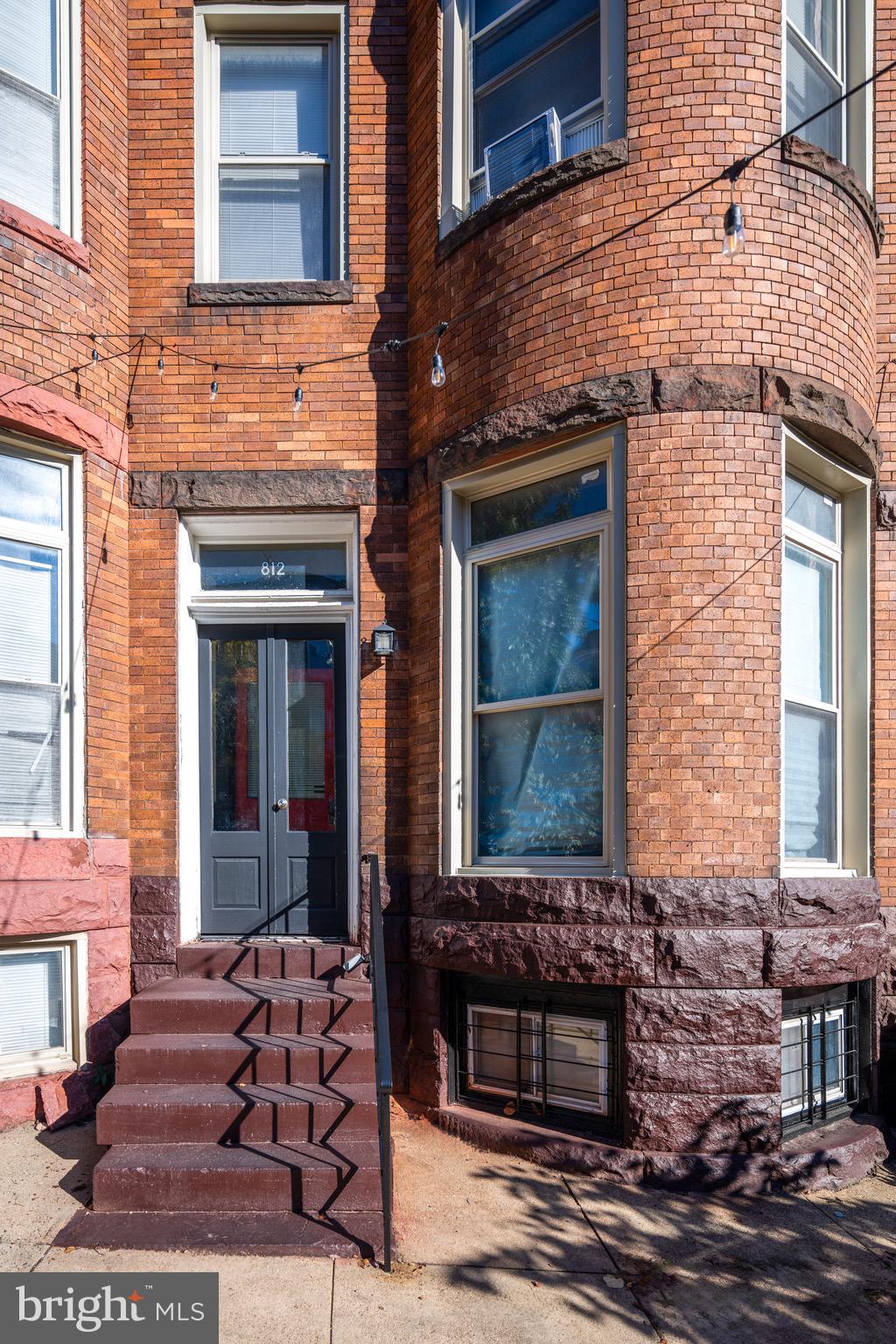 812 Newington Avenue Baltimore, MD 21217 - Photo 2 of 38 a front view of a brick building with glass windows