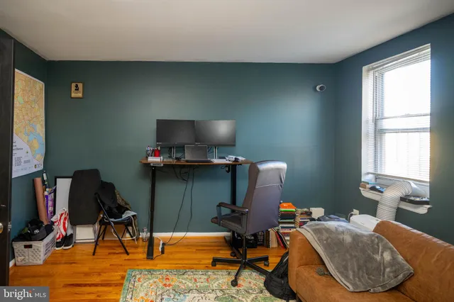 a view of a workspace with furniture and a window