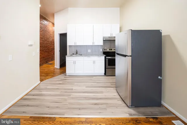 a kitchen with a refrigerator and a sink