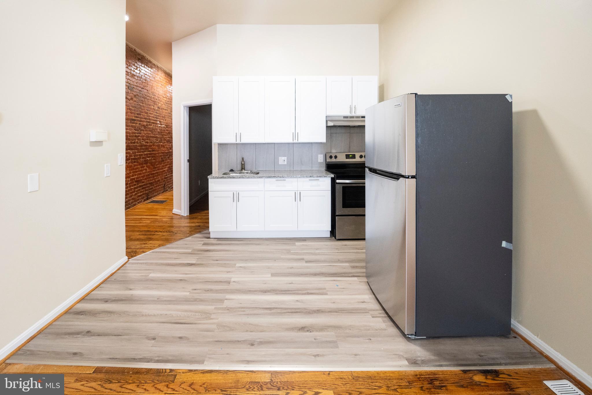 812 Newington Avenue Baltimore, MD 21217 - Photo 7 of 38 a kitchen with a refrigerator and a sink