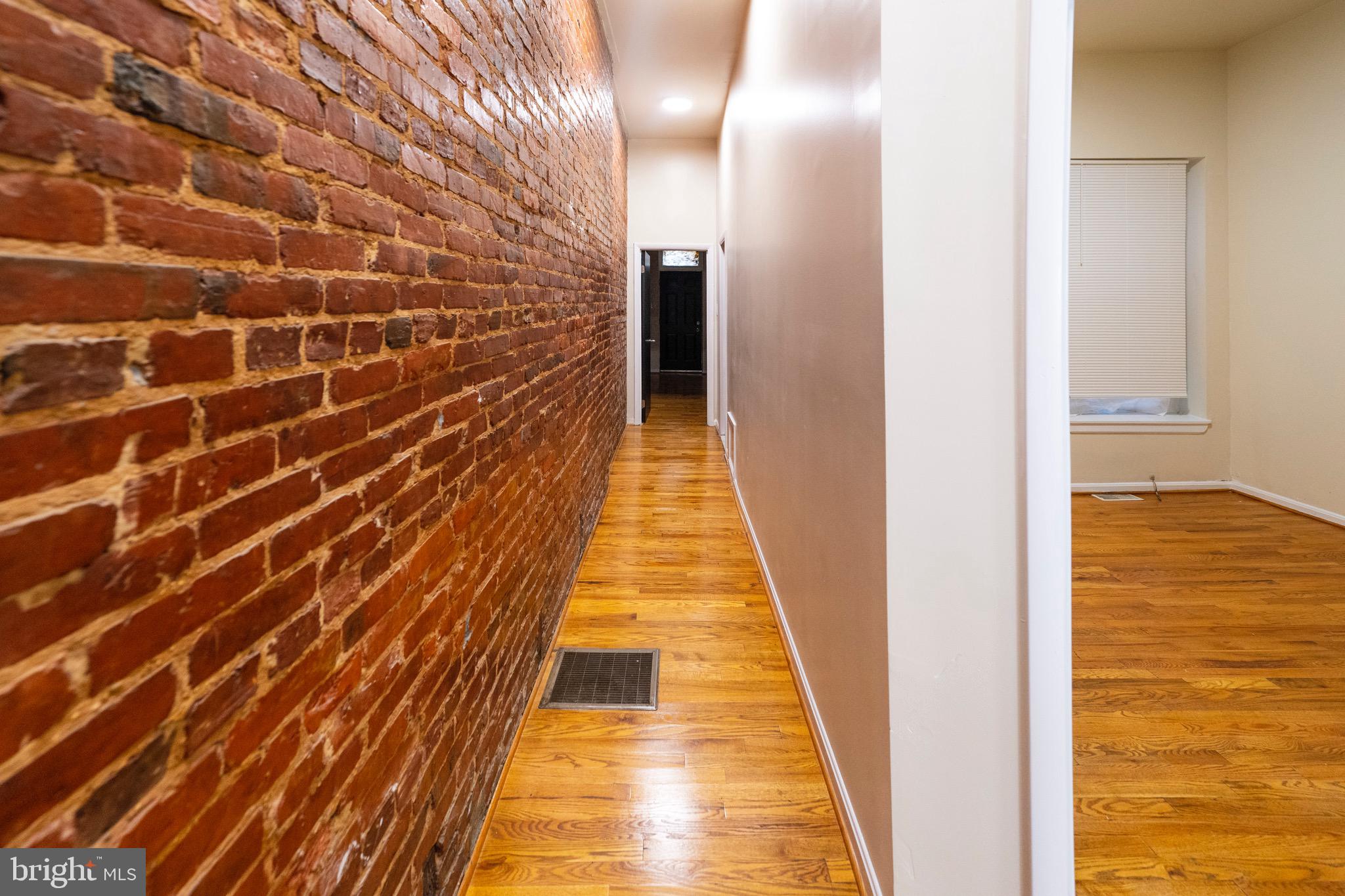 812 Newington Avenue Baltimore, MD 21217 - Photo 9 of 38 a view of hallway with wooden floor