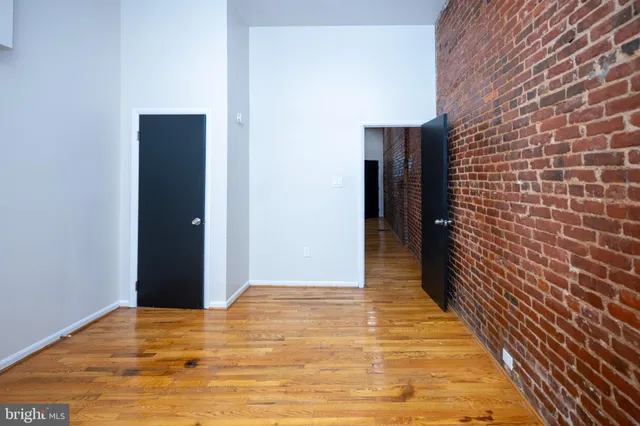 a view of hallway with wooden floor
