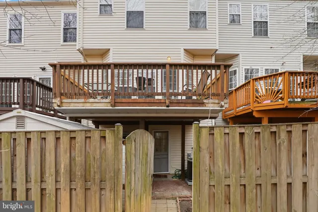 a view of a house with wooden fence