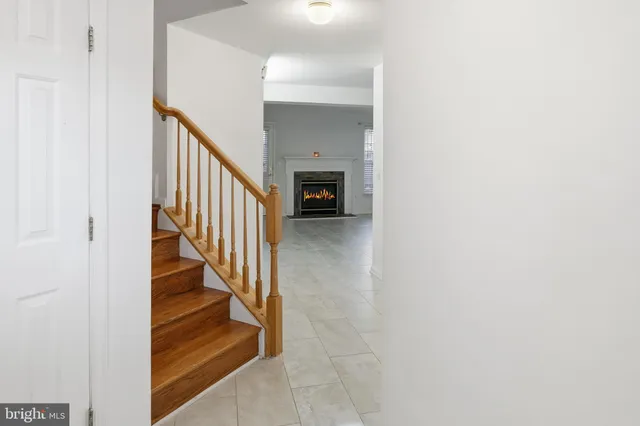 a view of a hallway with wooden staircase