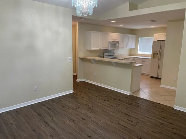 a kitchen with a refrigerator and a sink