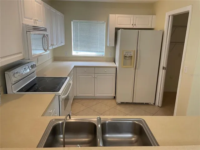a kitchen with a refrigerator and a sink
