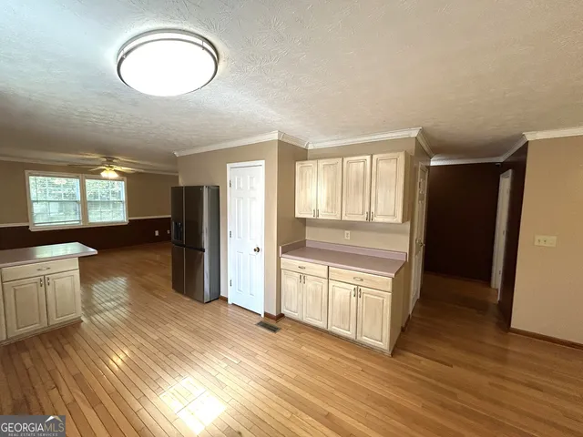 a view of a room with wooden floor