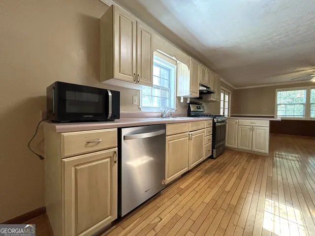 a living room with hard wood floors and a wooden floor