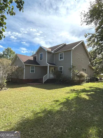 a front view of a house with yard and garage