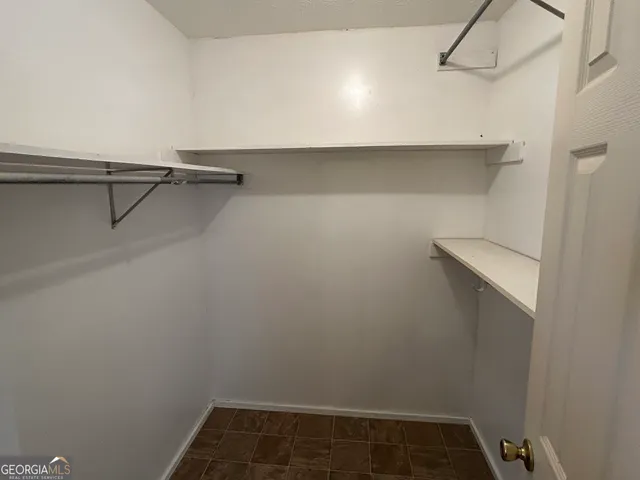 a bathroom with a toilet a sink a mirror and a window