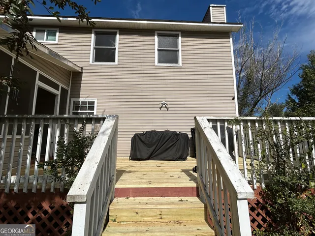 a view of a house with a yard and sitting area