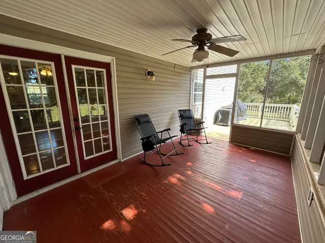 a view of a yard with plants and trees