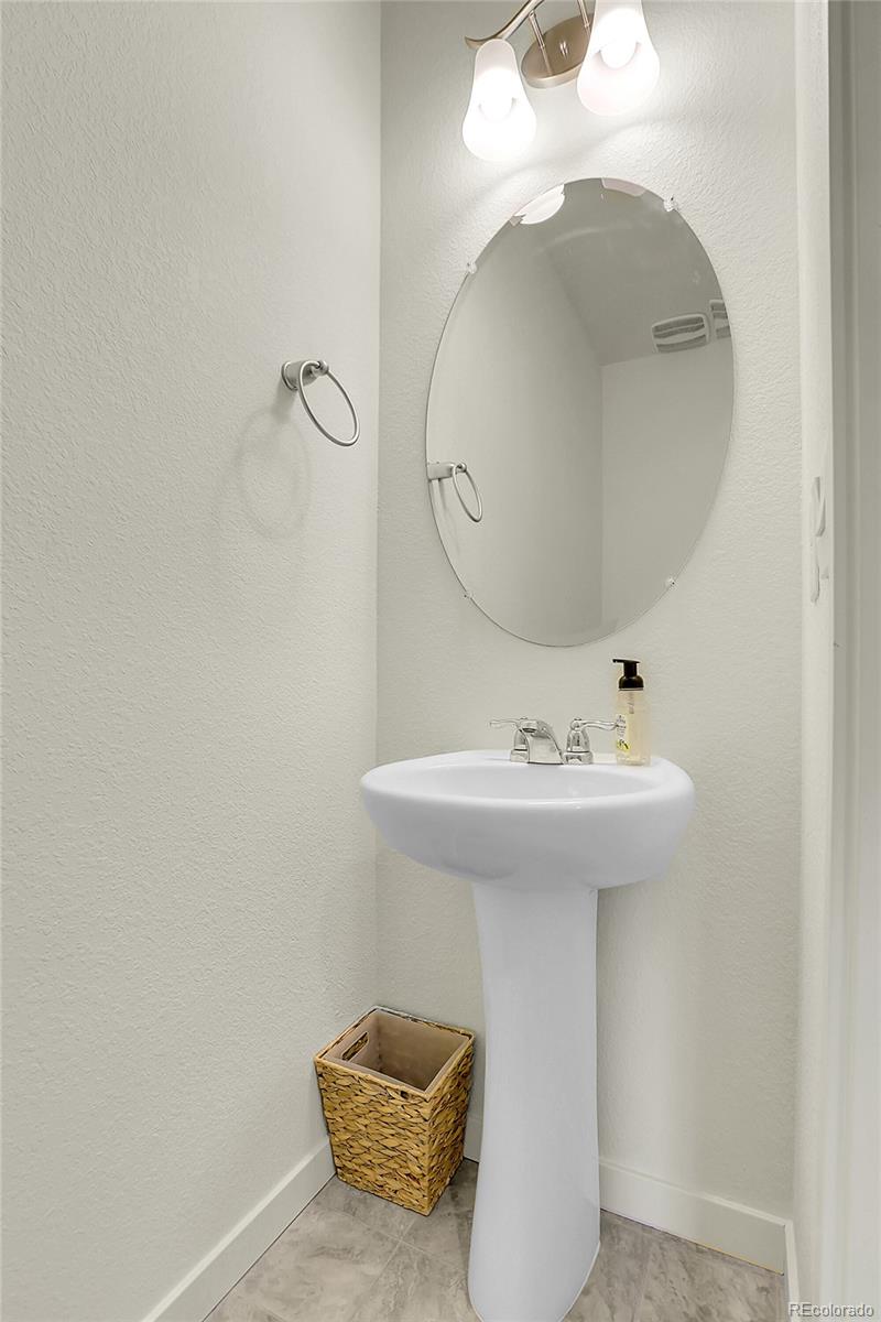 45840 Laceleaf Drive Bennett, CO 80102 - Photo 11 of 43 a bathroom with a sink and mirror