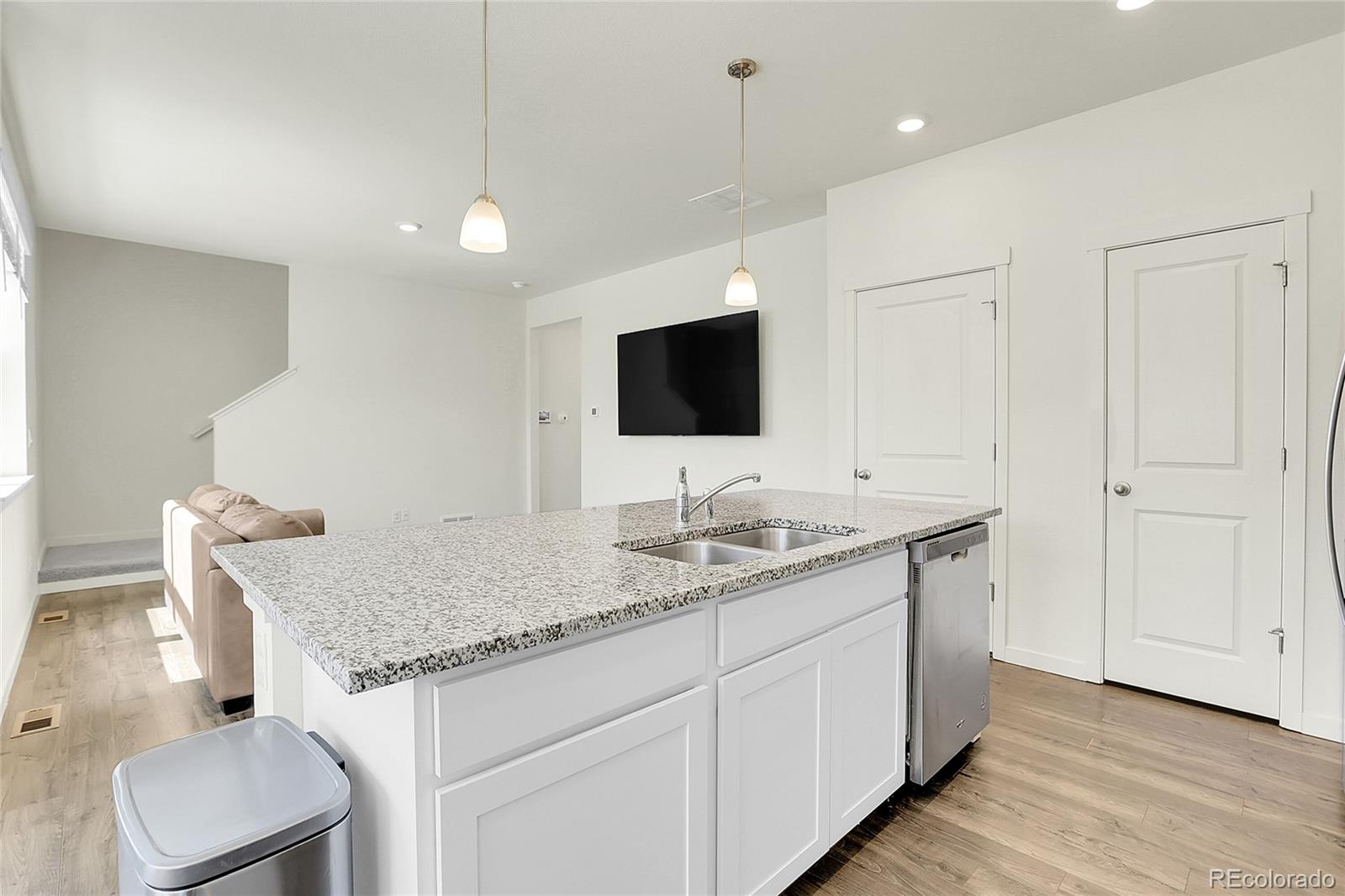 45840 Laceleaf Drive Bennett, CO 80102 - Photo 16 of 43 a bathroom with a granite countertop sink and a mirror