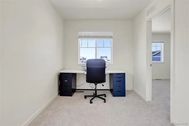 a bedroom with a bed and a lamp