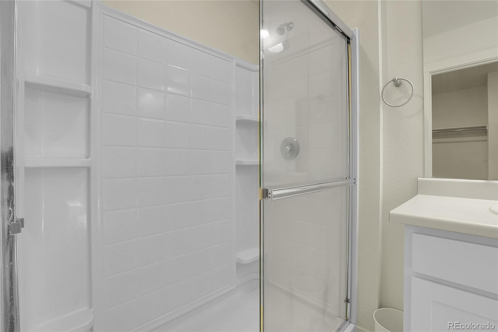 45840 Laceleaf Drive Bennett, CO 80102 - Photo 29 of 43 a bathroom with a shower and a sink