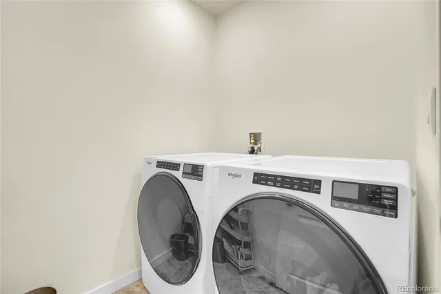 a front view of a house with yard and sitting area