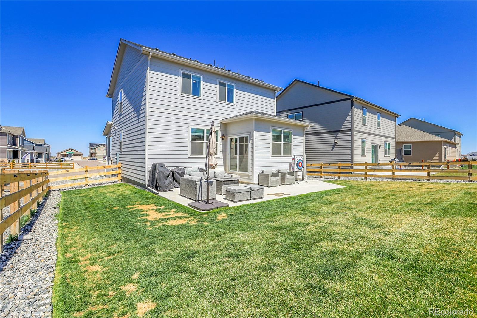 45840 Laceleaf Drive Bennett, CO 80102 - Photo 37 of 43 a front view of a house with a yard table and chairs