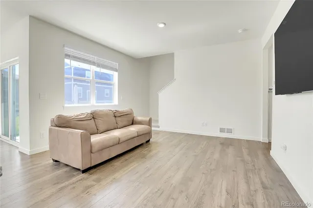 a kitchen with kitchen island white cabinets and stainless steel appliances