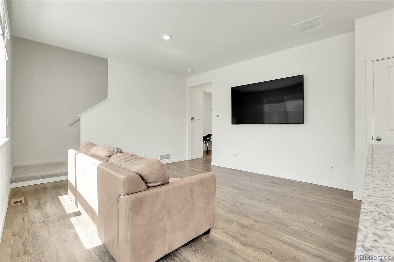 45840 Laceleaf Drive Bennett, CO 80102 - Photo 10 of 43 a living room with furniture and a flat screen tv
