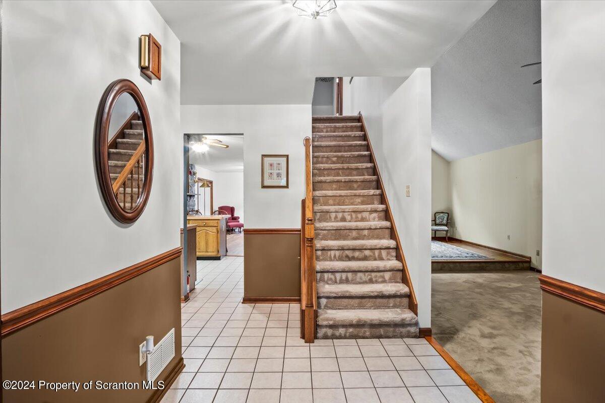 925 Apple Tree Road Pittston, PA 18643 - Photo 27 of 86 a view of a hallway with entryway wooden floor and front door