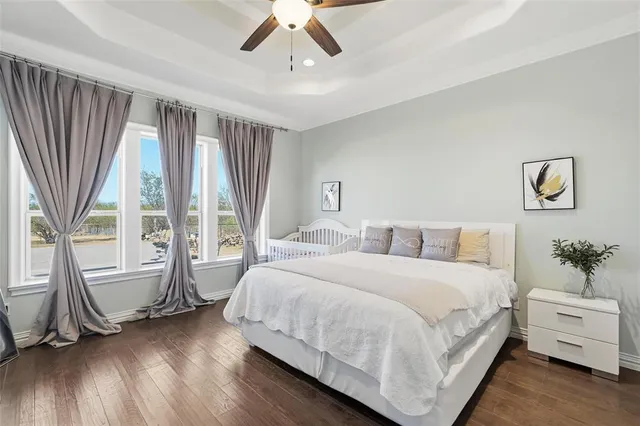 a bedroom with a large bed and a large window