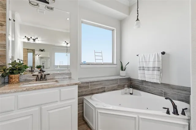 a bathroom with a bathtub and a sink