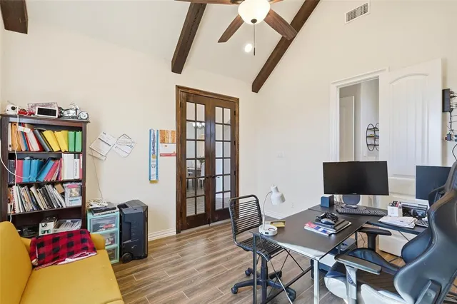 a view of a workspace with furniture and a book shelf