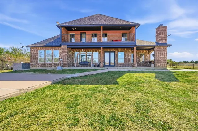 a front view of a house with a yard table and chairs